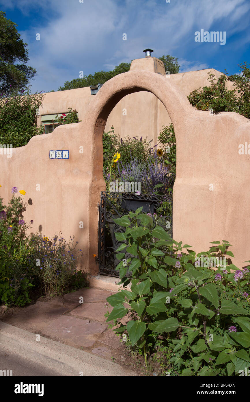 Arched front gate to a house in the Pueblo revival style architecture of the Southwest in Santa Fe, New Mexico Stock Photo