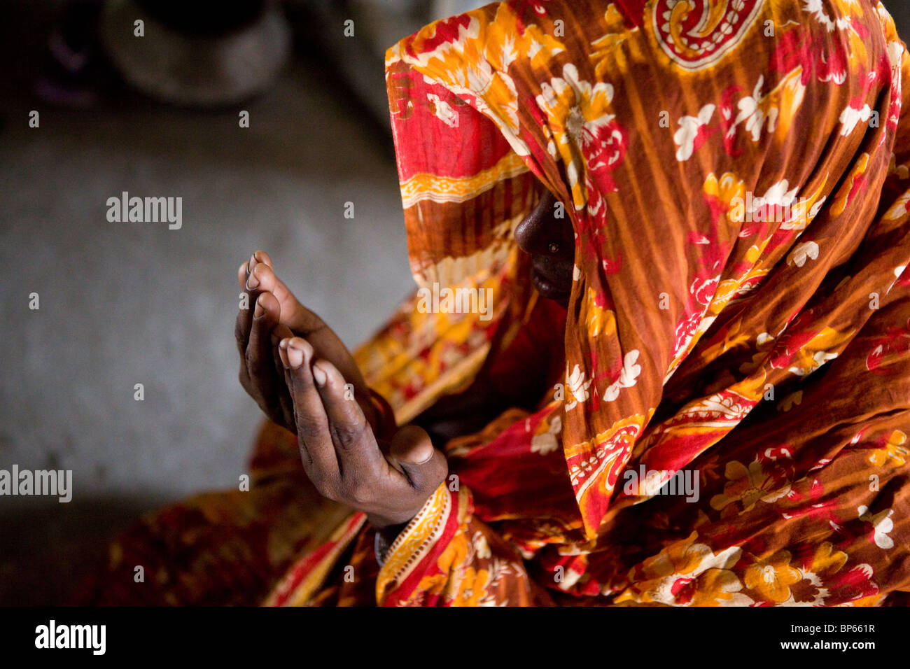 Woman praying at home in Bangladesh Stock Photo