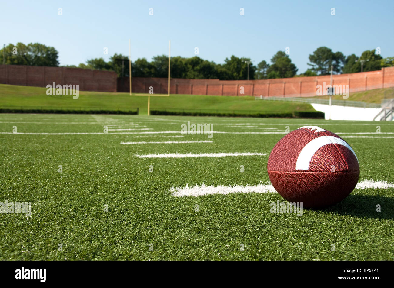 American Football On Field With Goal Post In Background Stock Photo Alamy