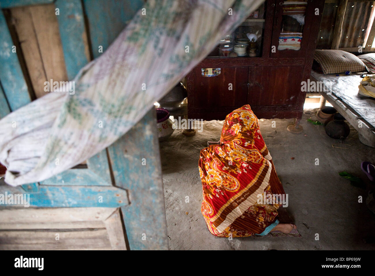 Woman praying at home in Bangladesh Stock Photo