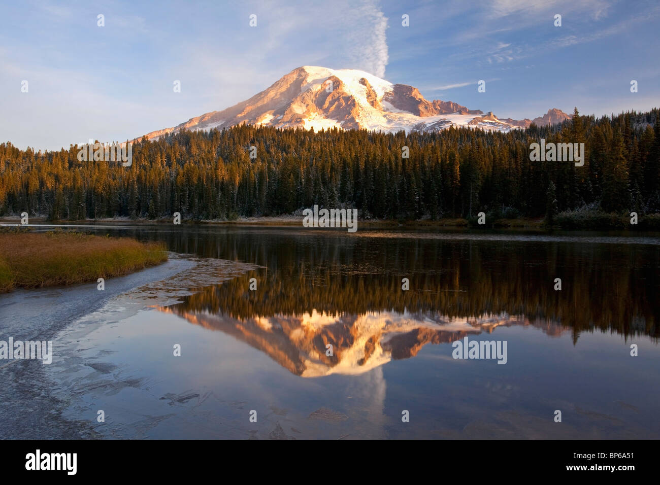 Washington, United States Of America; Reflection Of Mount Rainier In A Lake With Ice On The Surface In Mt. Rainier National Park Stock Photo