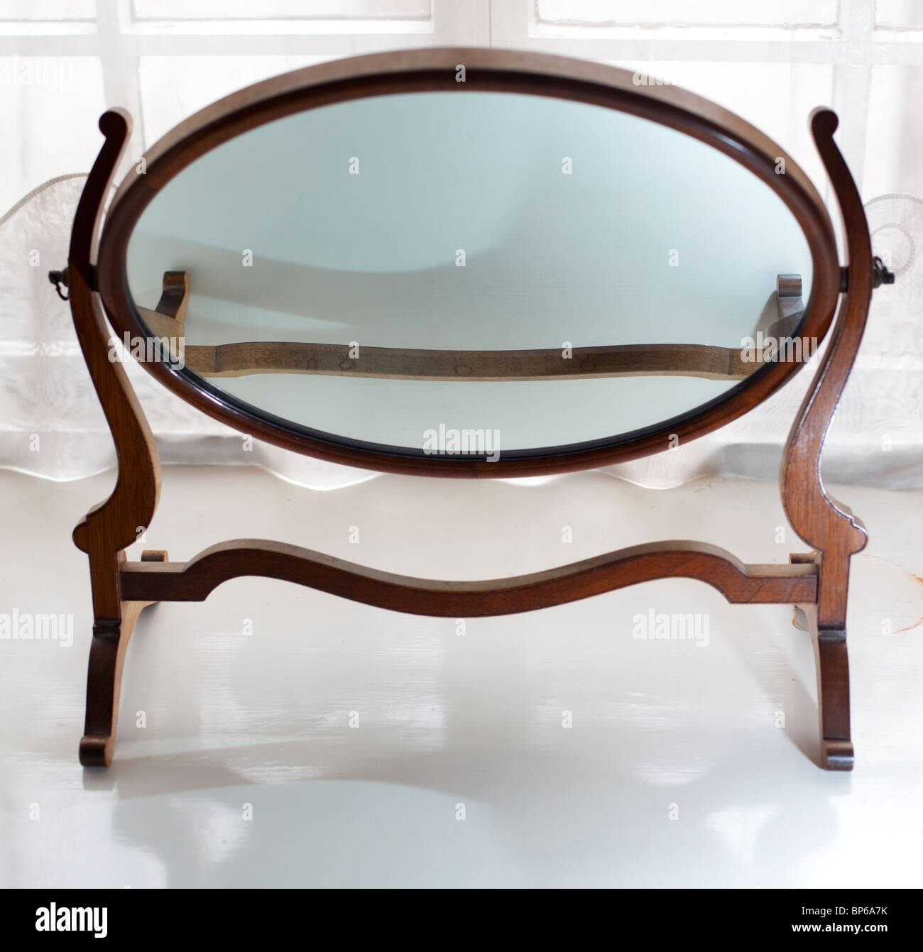 Oval mirror in wooden frame Stock Photo