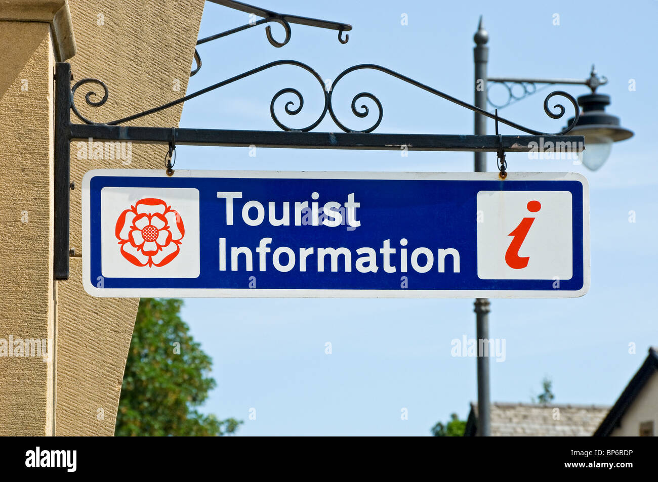 Close up of visitor tourist information sign hanging on wall outside