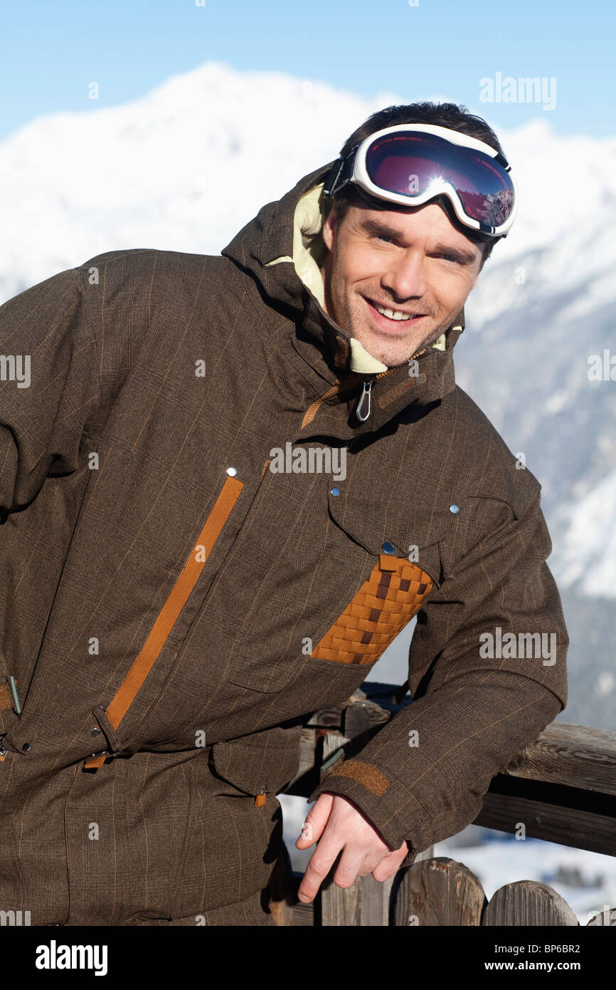 Young man in ski wear smiling at camera Stock Photo - Alamy