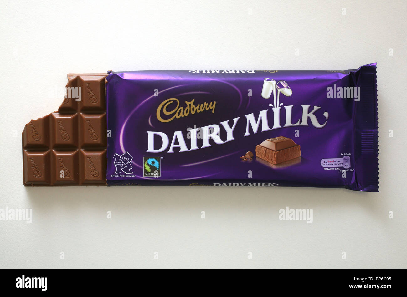 A bar of Cadbury Dairy Milk chocolate in it's wrapper with a bite taken out of it. Stock Photo