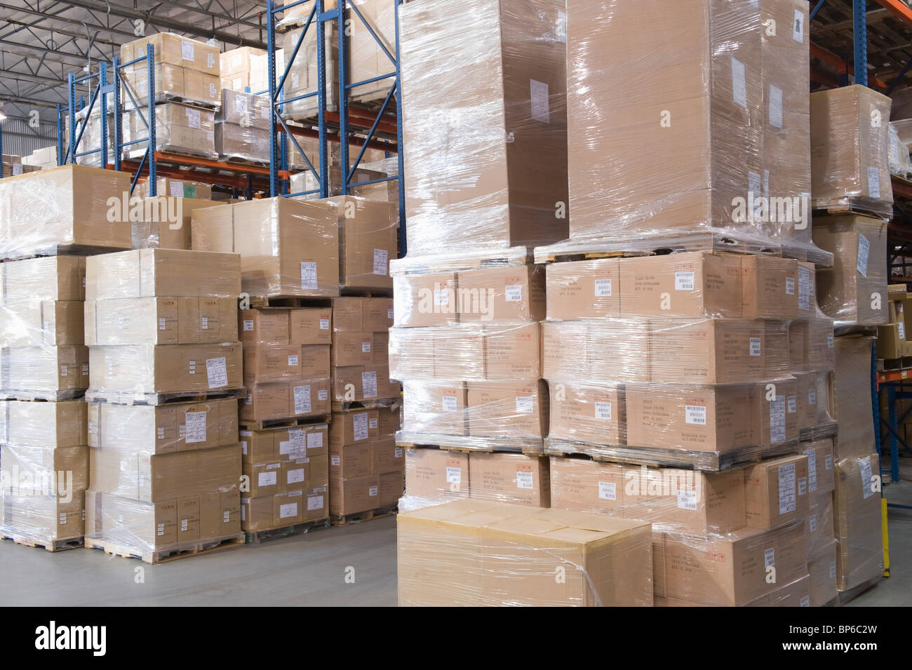 Cardboard boxes stacked in distribution warehouse Stock Photo Alamy