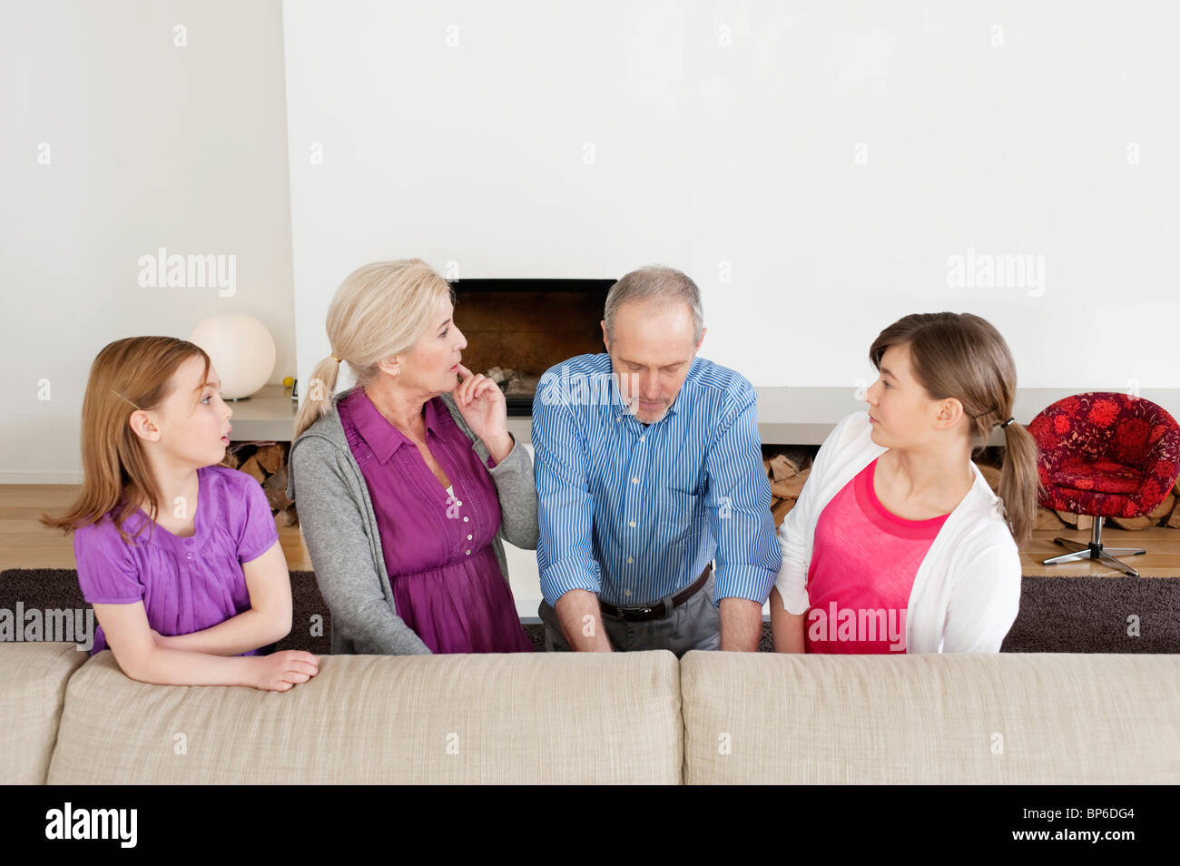Family in a living room Stock Photo Alamy