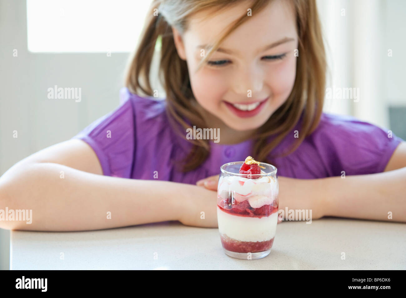 Girl looking at a glass of ice cream Stock Photo Alamy