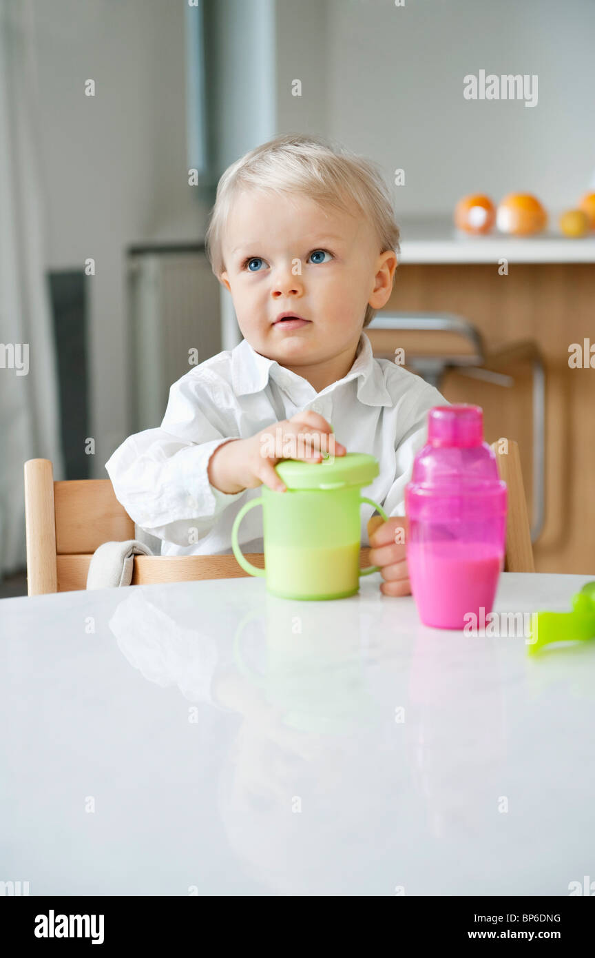 Boy sitting at a dining table Stock Photo Alamy