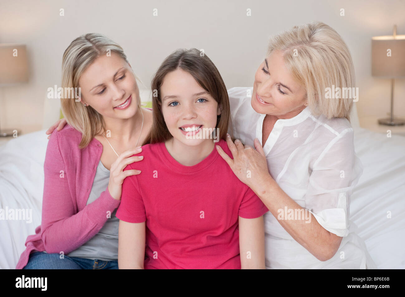 Portrait of a girl sitting with her mother and grandmother Stock Photo ...