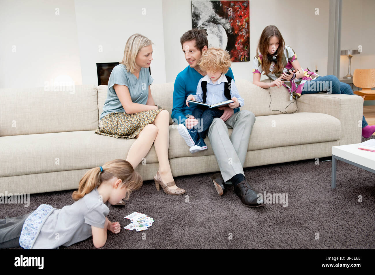 Family in a living room Stock Photo Alamy