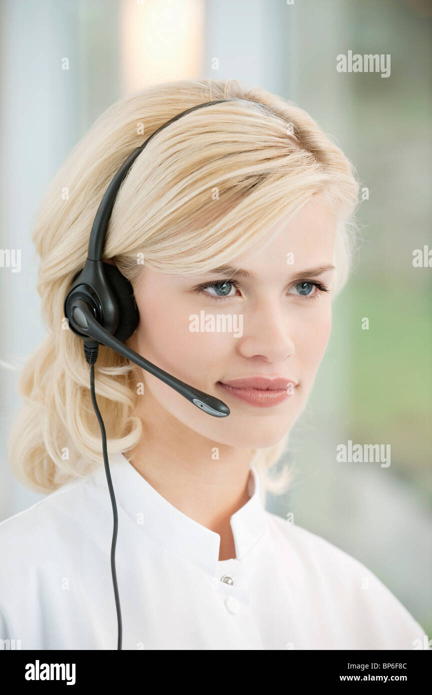 Close-up of a female customer service representative wearing a headset ...
