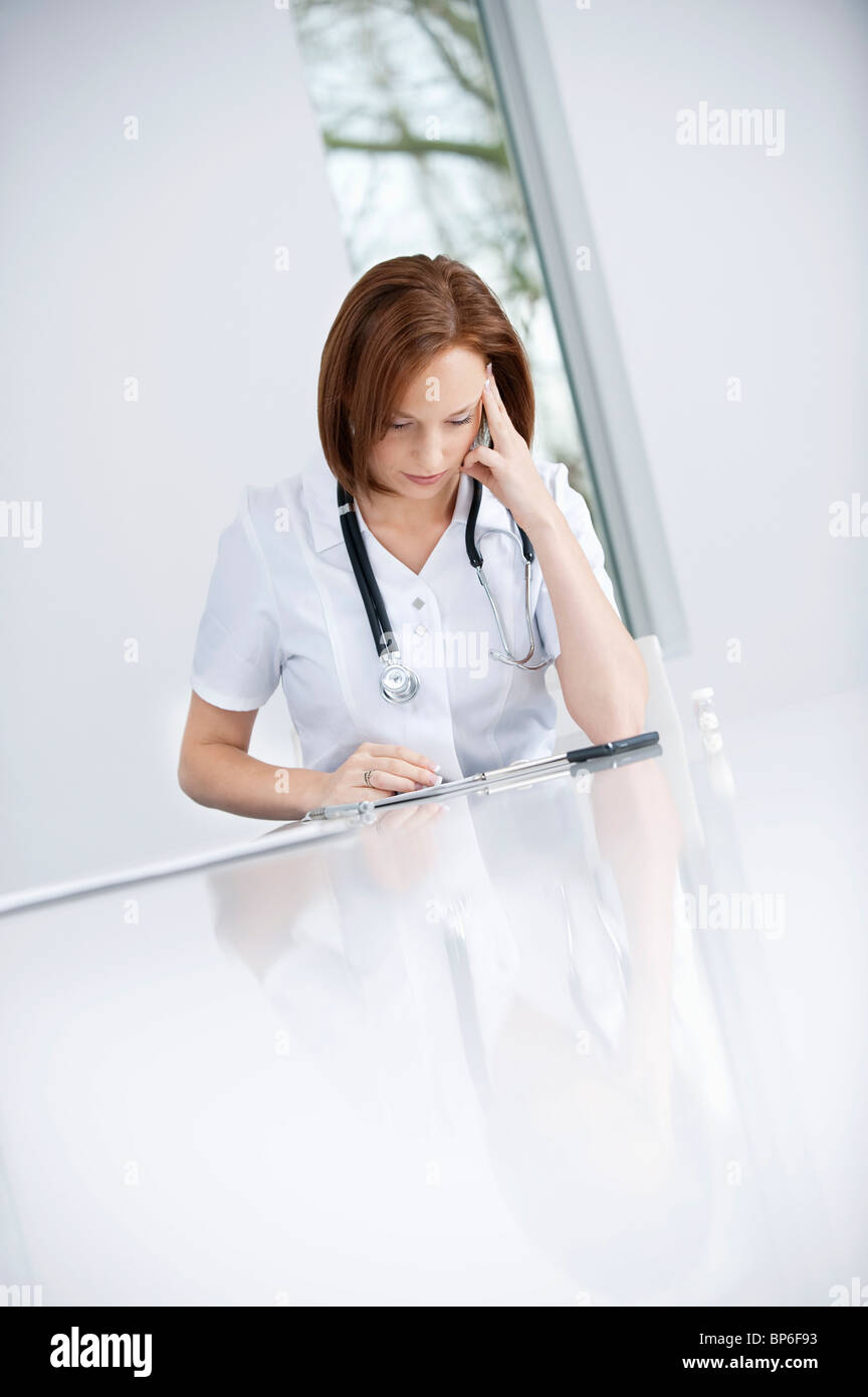 Woman doctor stethoscope sitting hi-res stock photography and images ...