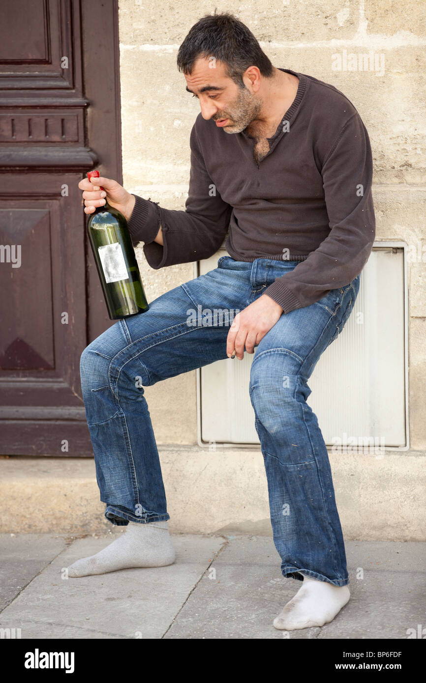 drunk man standing near house door in city street Stock Photo