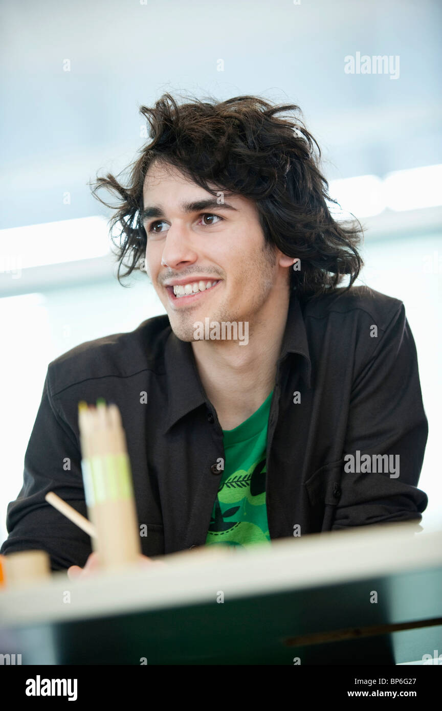 Businessman smiling in an office Stock Photo - Alamy