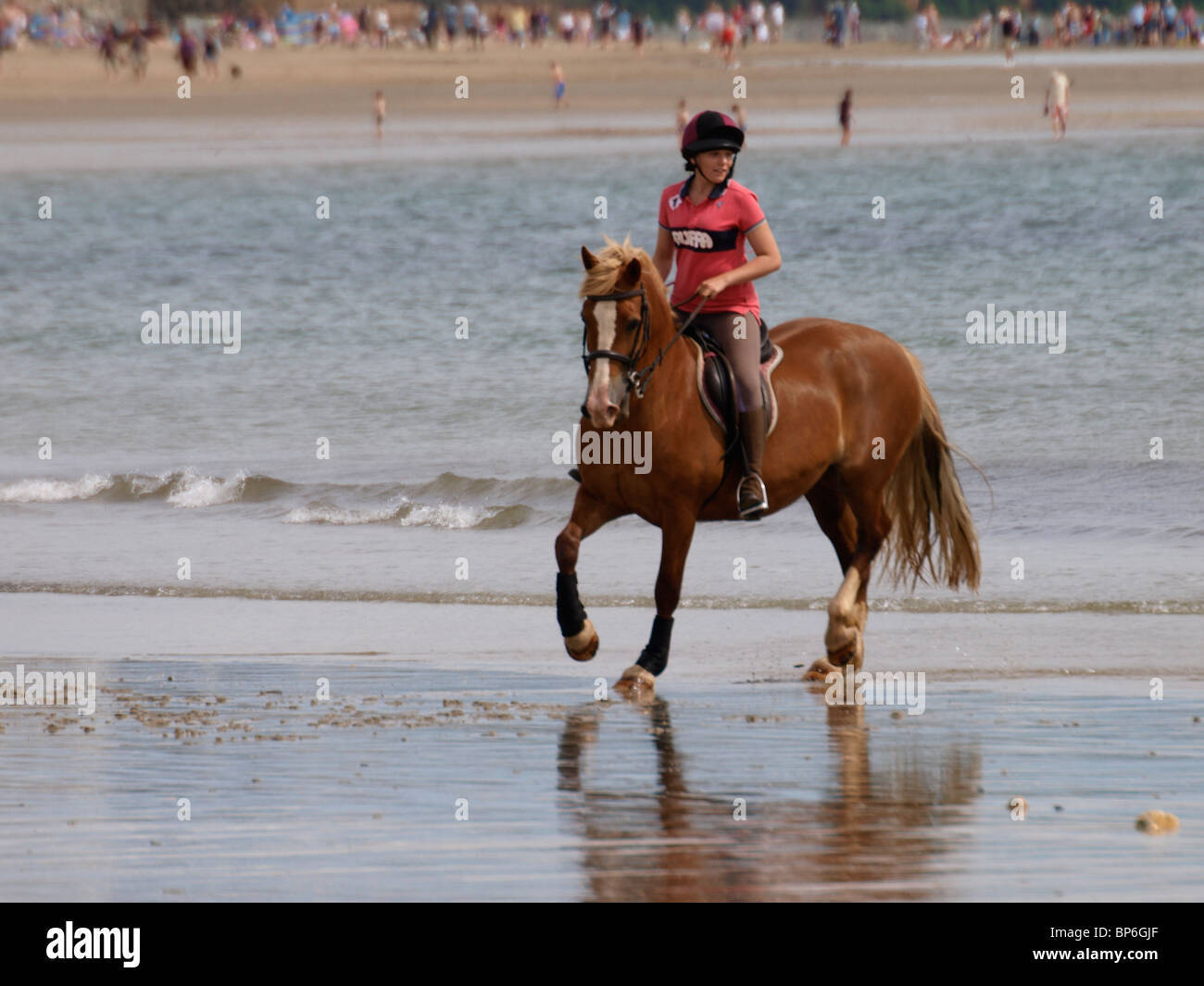 Woman riding her horse along the beach around Mounts Bay, marazion, Cornwall, UK. Stock Photo