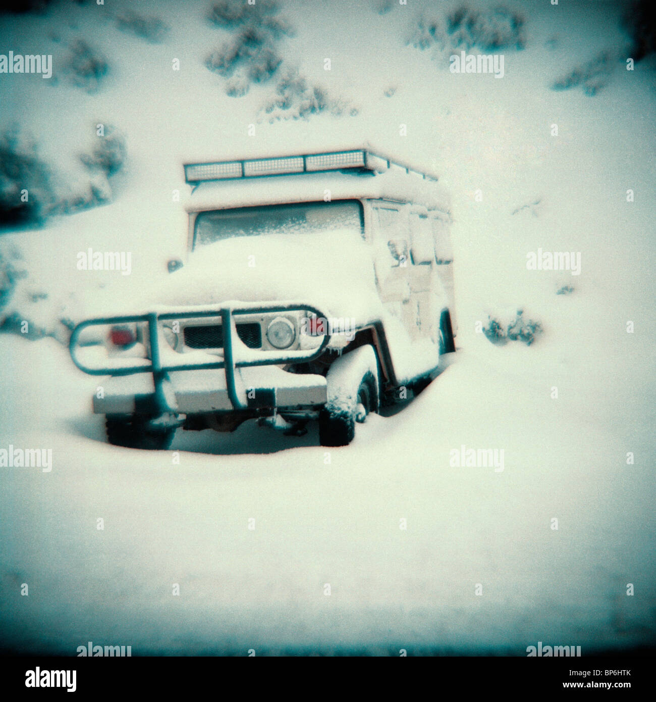 A vintage style photograph of a 4WD in snow Stock Photo