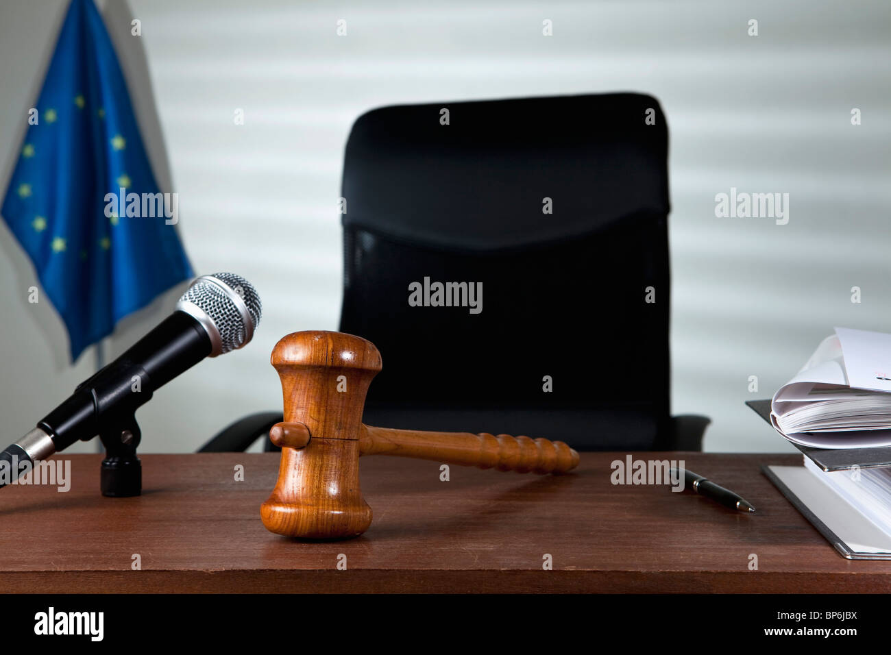 A gavel on a judge's desk in an empty courtroom Stock Photo