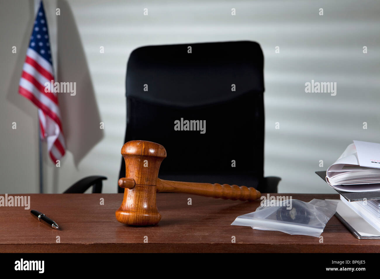 A gavel on a judge's desk in an empty courtroom Stock Photo