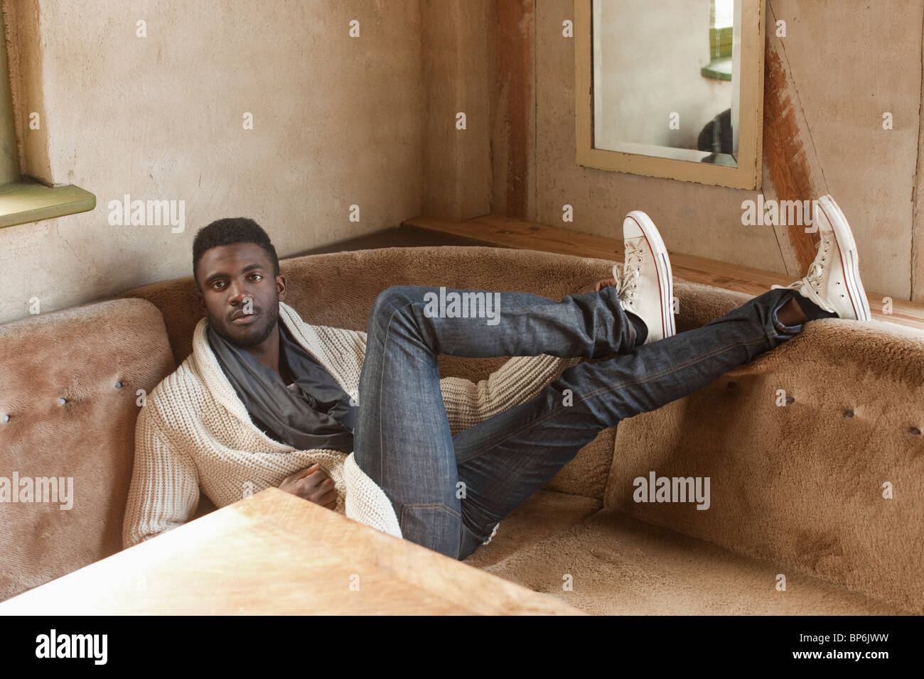 Stylish man reclining in booth hi-res stock photography and images - Alamy