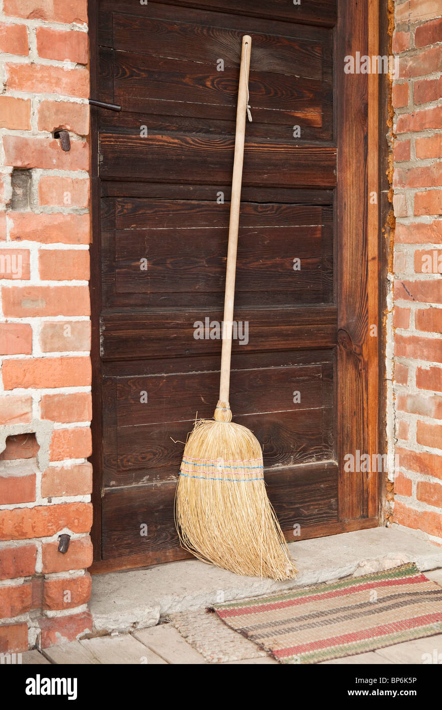 A broom leaning against a door Stock Photo Alamy