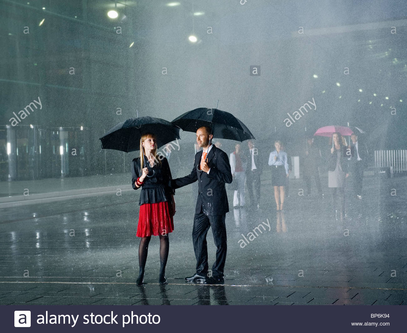 A couple standing in the rain under umbrellas Stock Photo 30879664 Alamy