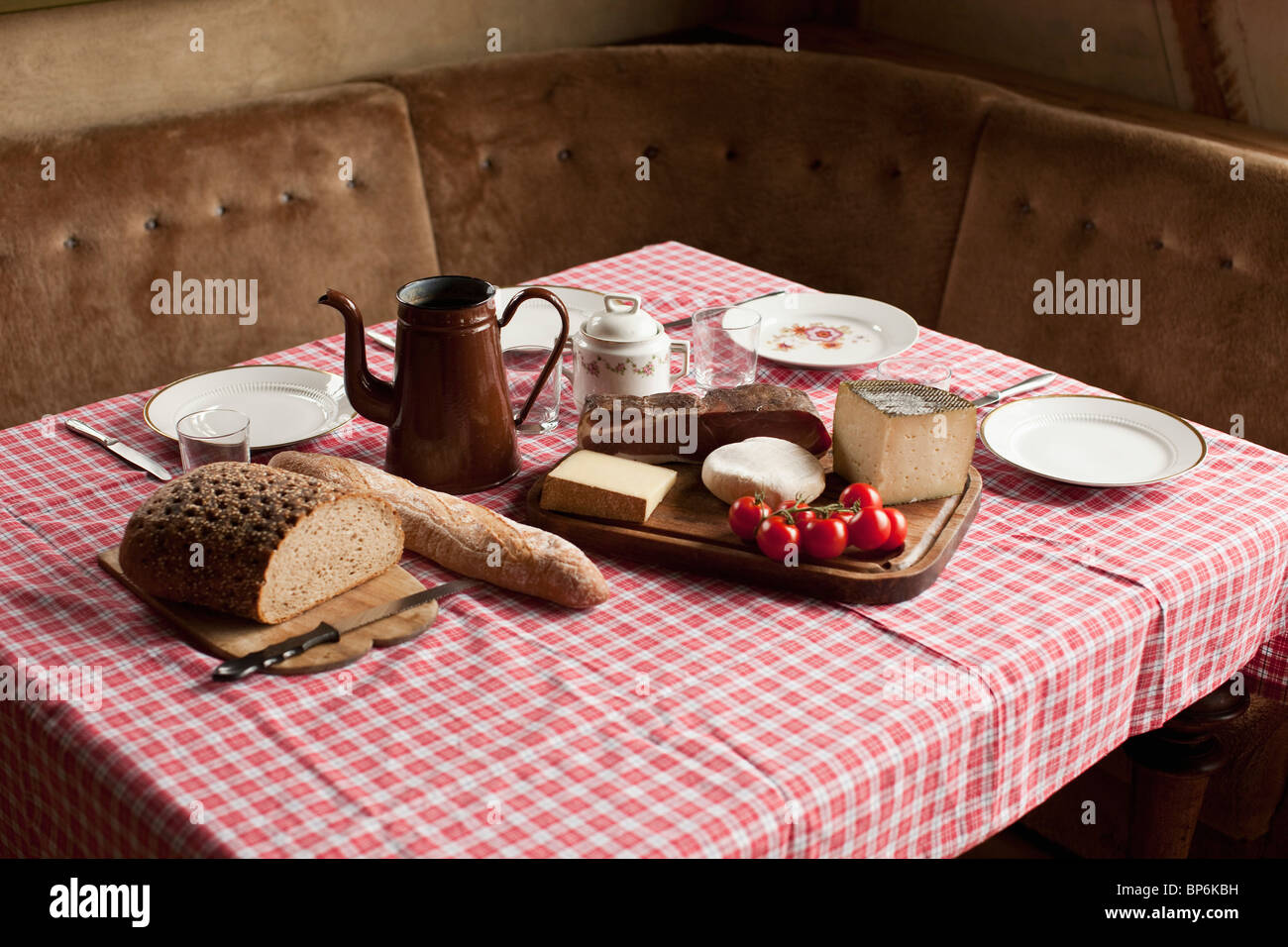 A simple rustic meal laid out on a set table Stock Photo