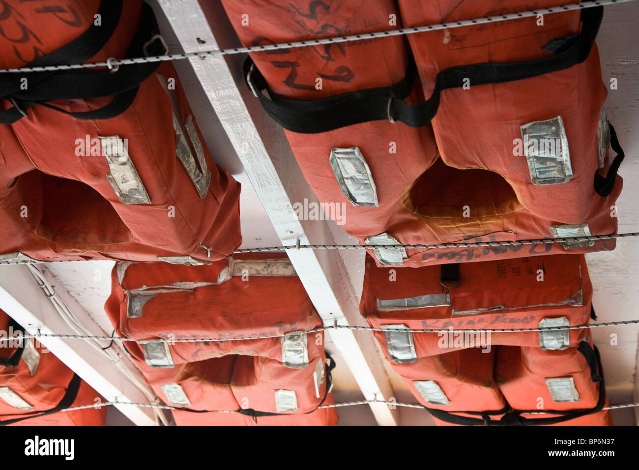 Detail of life vests stowed on a ship Stock Photo