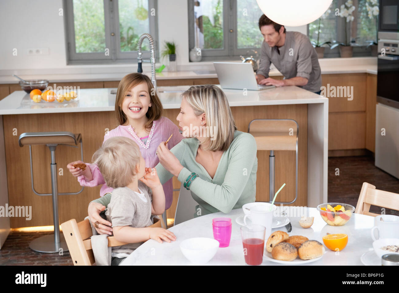 Family at a breakfast table Stock Photo - Alamy