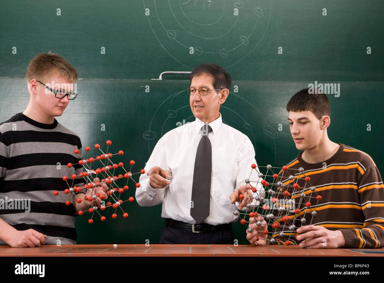 A teacher showing students molecular structure models Stock Photo