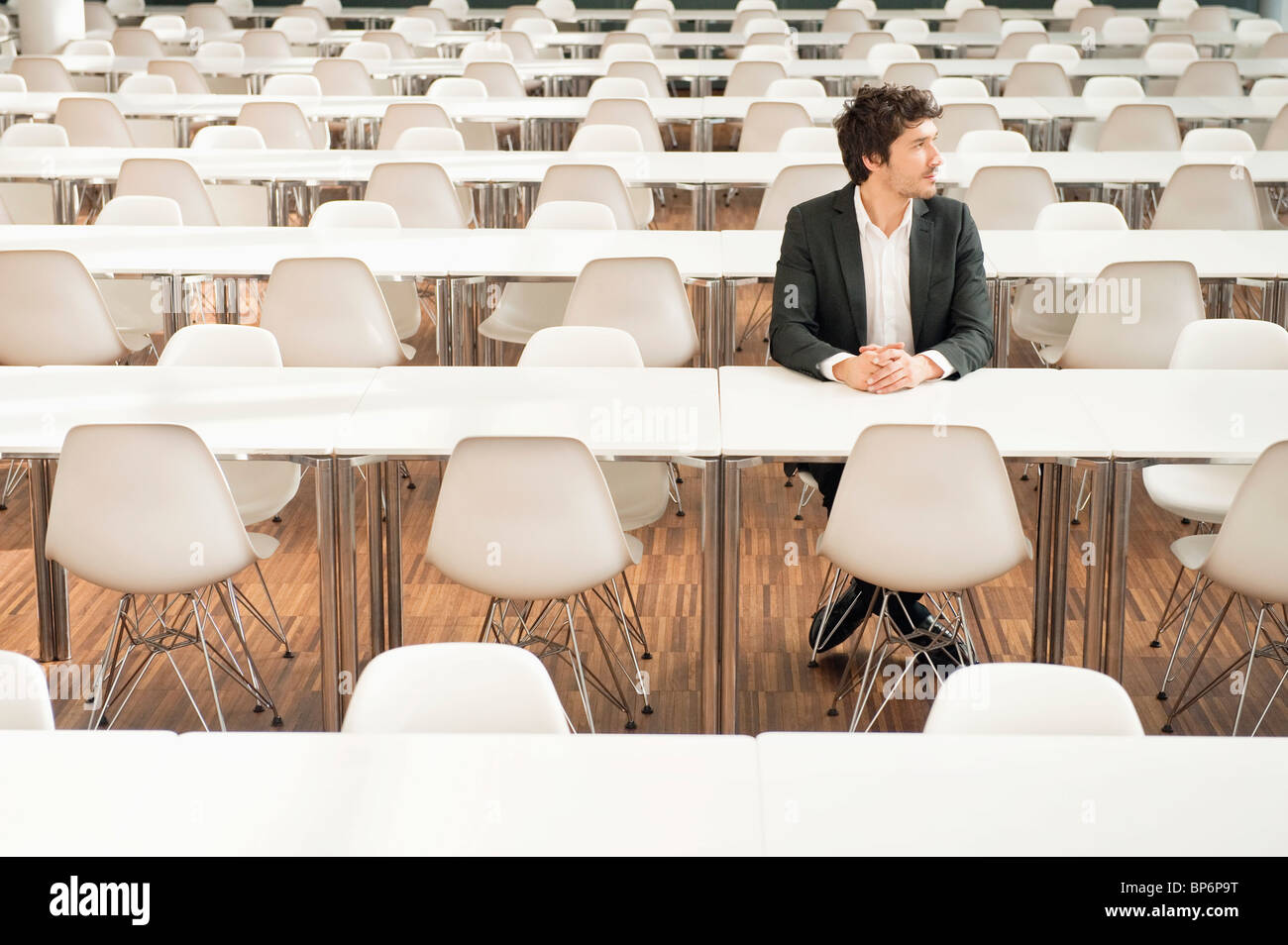 Businessman sitting at a cafeteria and thinking Stock Photo