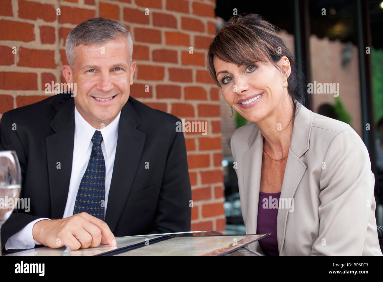 Portrait of two business people at a restaurant Stock Photo