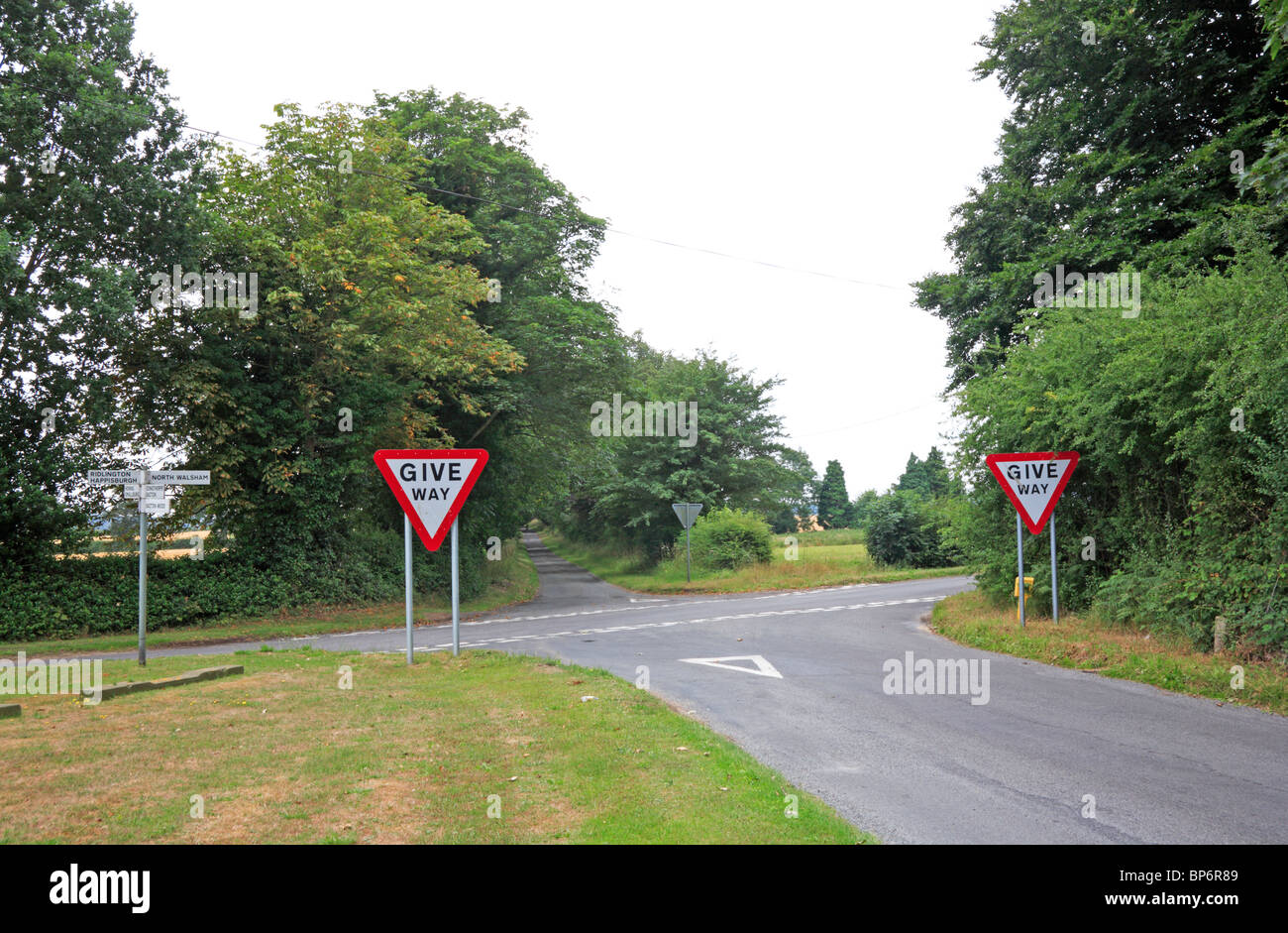 A country crossroads with road signs at Witton, near North Walsham, Norfolk, England, United Kingdom. Stock Photo