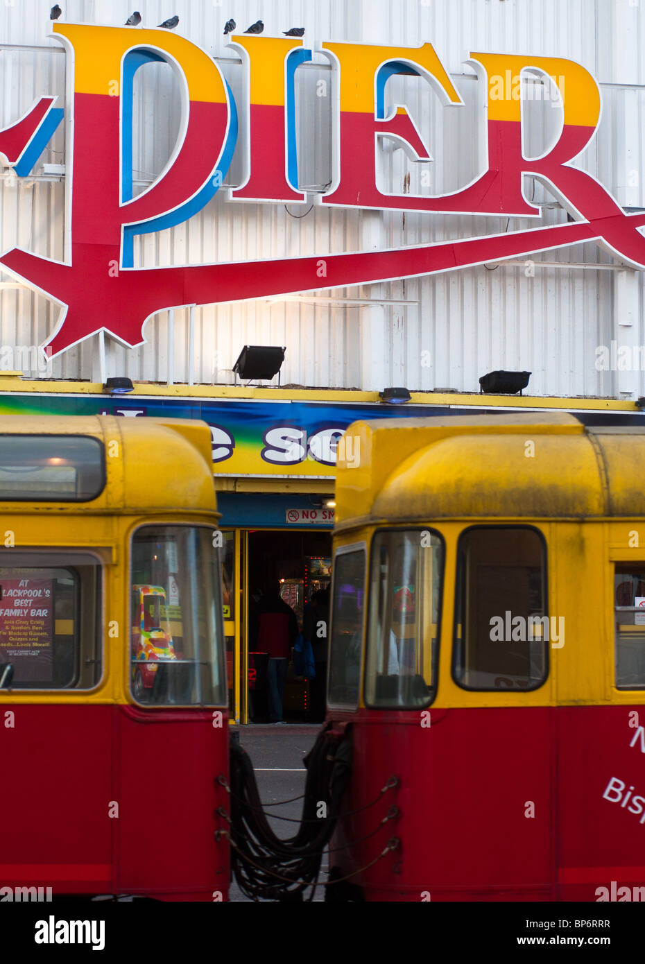 A tram goes past Blackpool's South Pier. England. Stock Photo