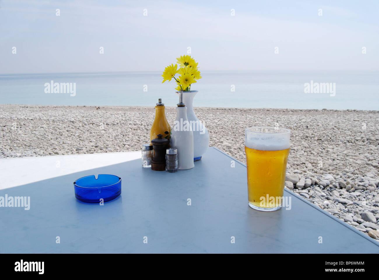 Flowers Ashtray Glass Of Beer Condiments On Table At