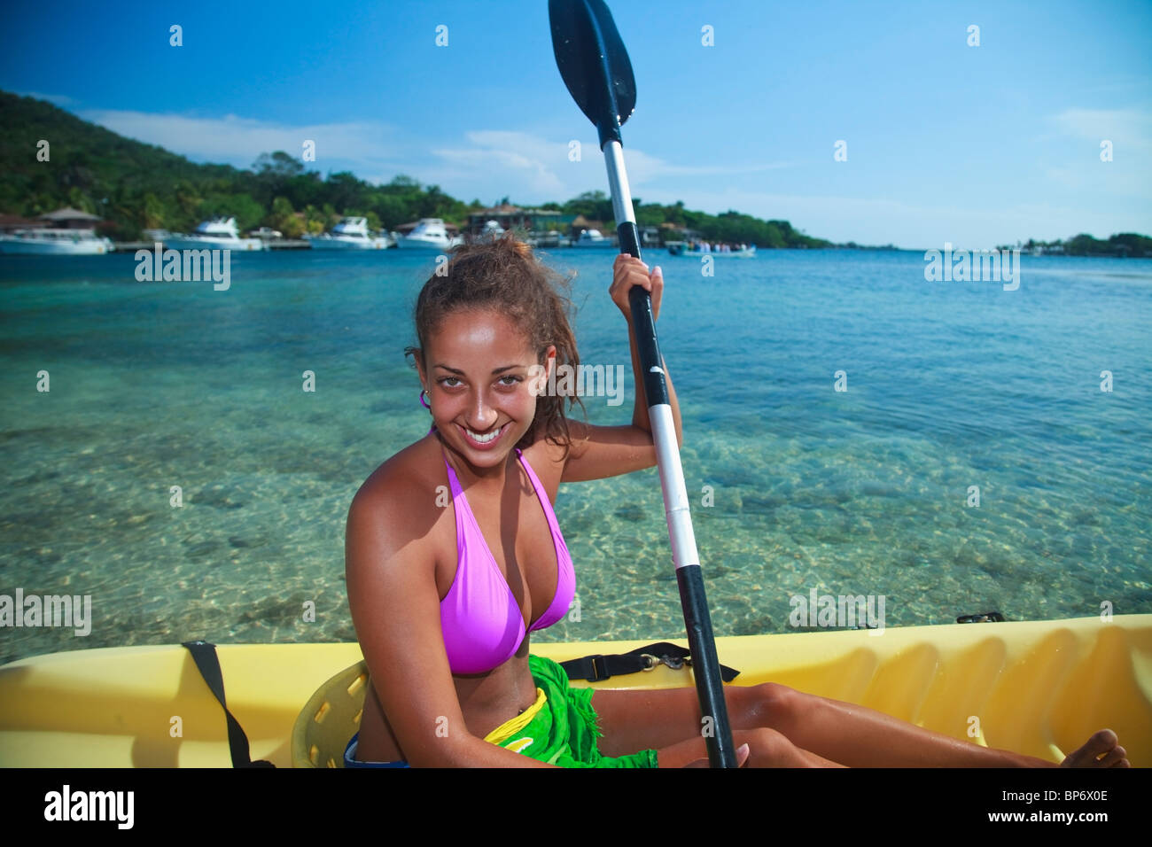 Woman stretching at Roatan Beach Honduras stock photo 