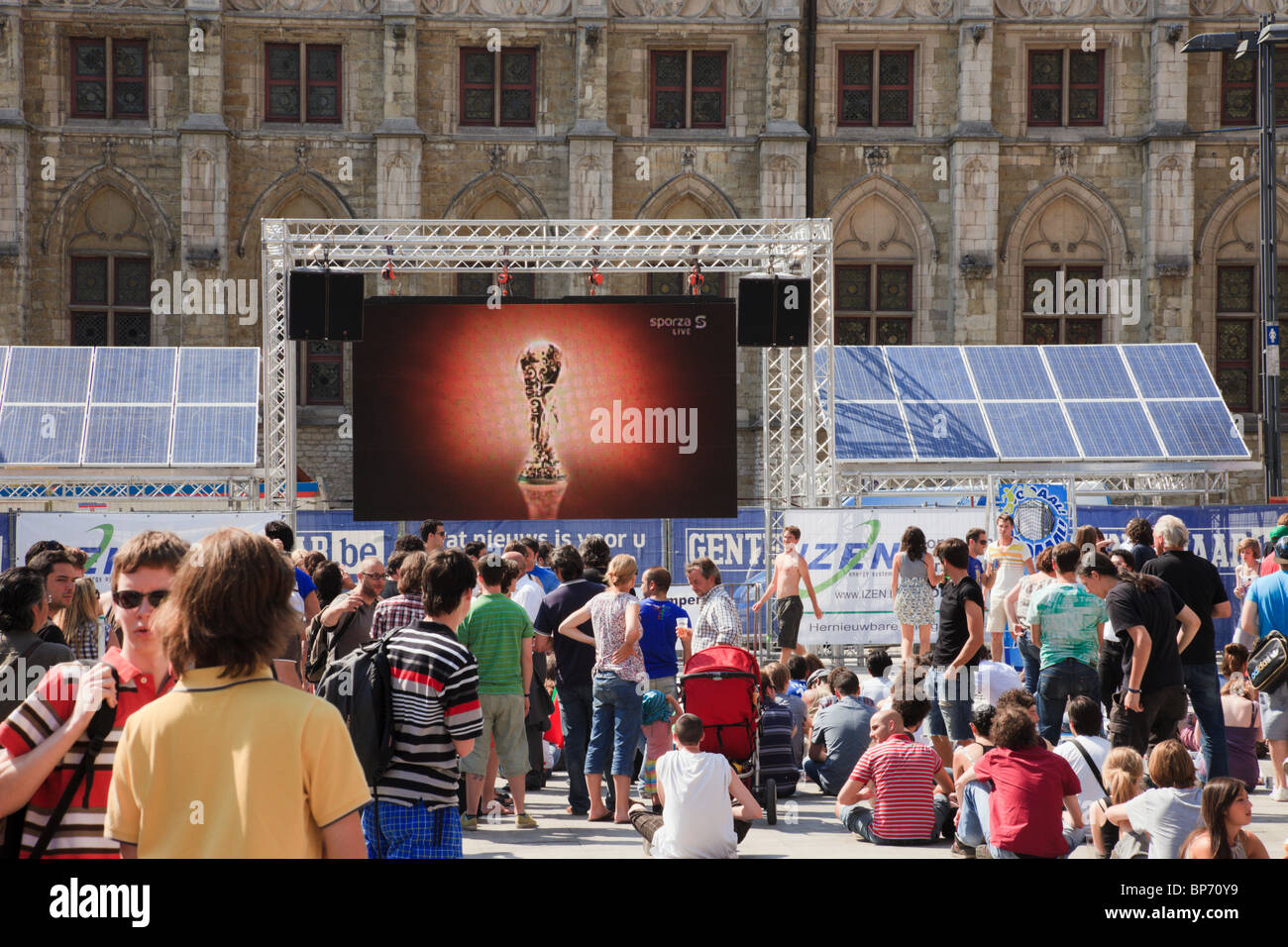 Crowd of people watching World Cup live football match on big screen solar powered television