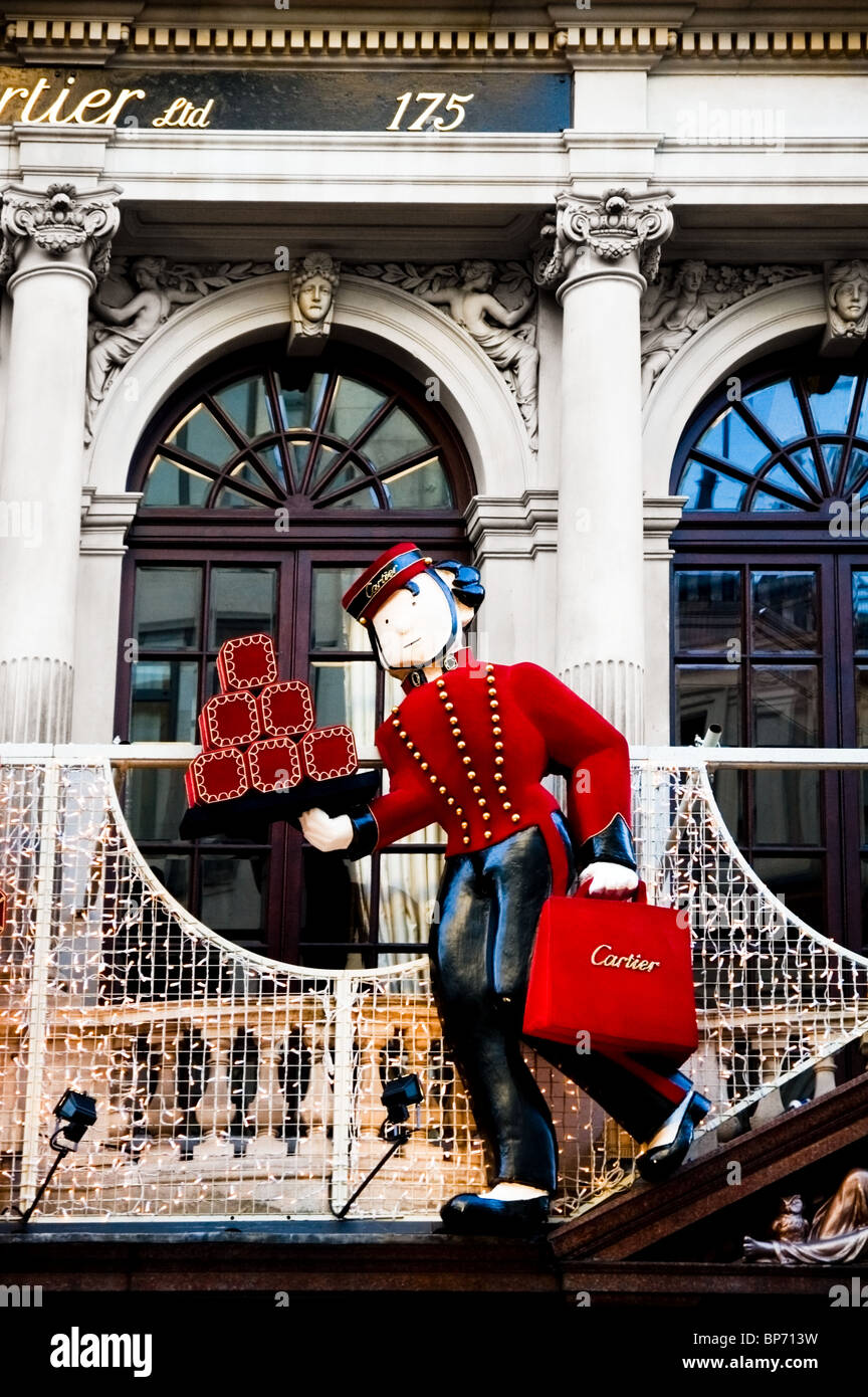 Cartier shop outside, exterior Christmas window decoration with smart butler, presents, Bond
