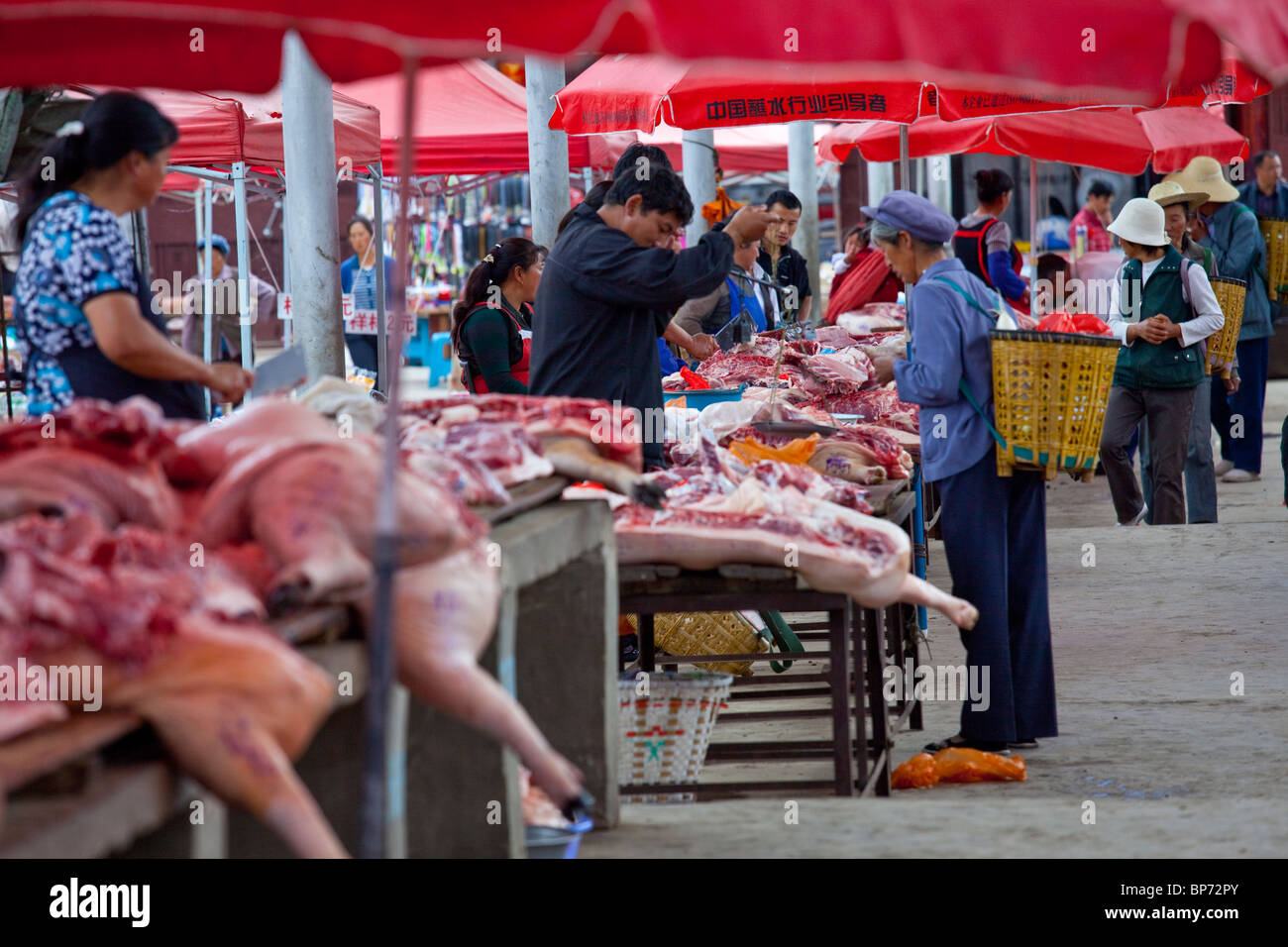 Pork on market day in Shaxi Village, Yunnan Province, China Stock Photo ...