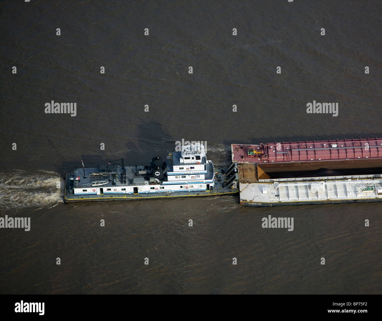 aerial view above Mississippi Inland Marine tug boat pushing barges Mississippi River Baton Rouge Louisiana Stock Photo