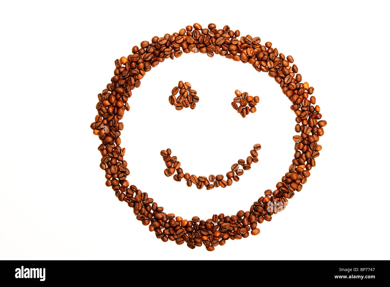 laughing smiley made of coffee beans on white background Stock Photo