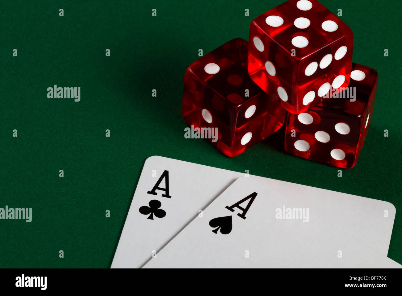 two aces and three dices on green background Stock Photo