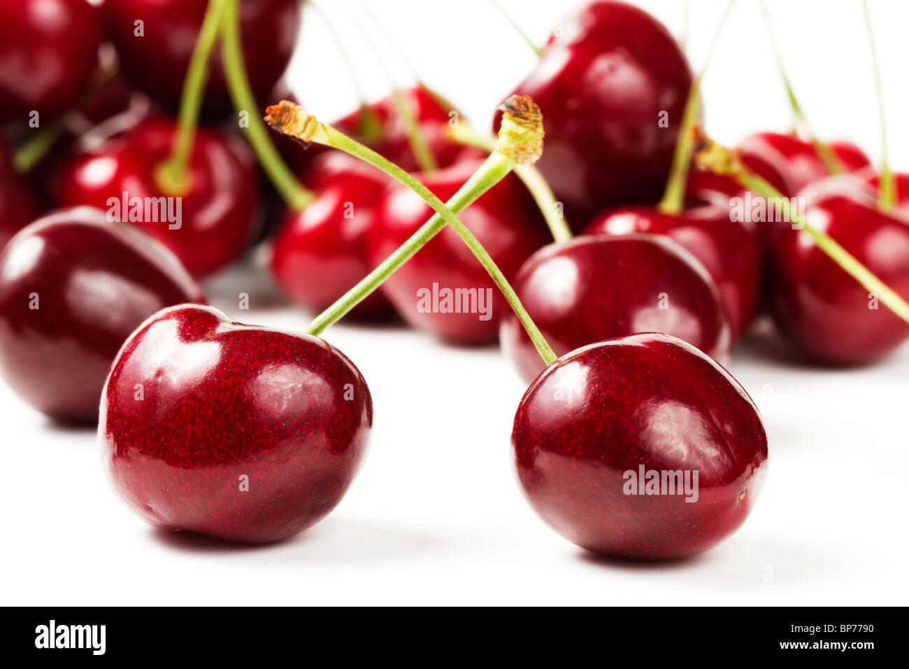 two cherries in front of many on white background Stock Photo Alamy