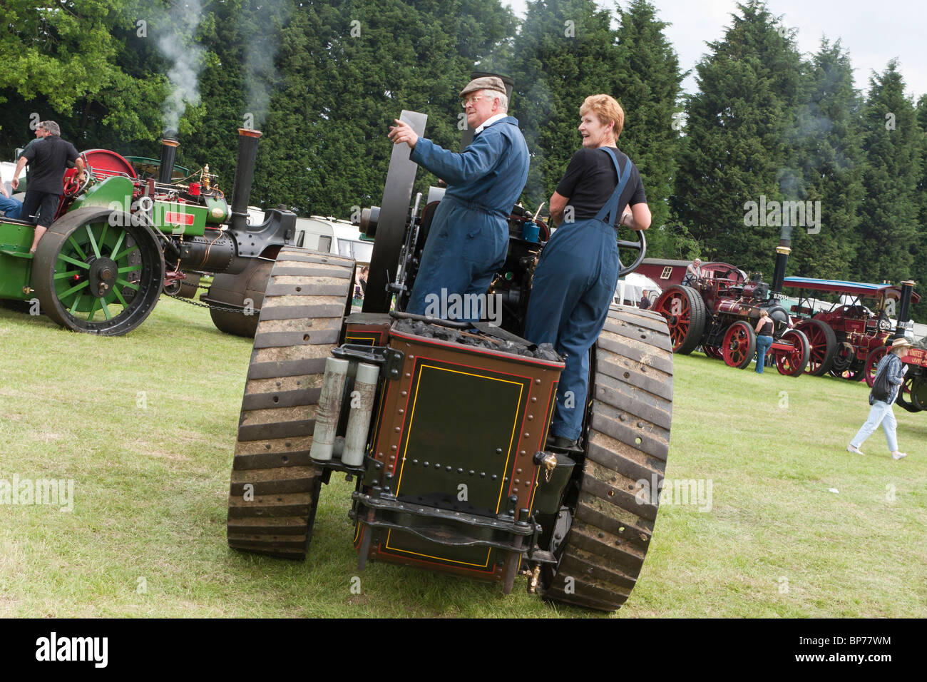 A couple of people driving a traction engine Stock Photo