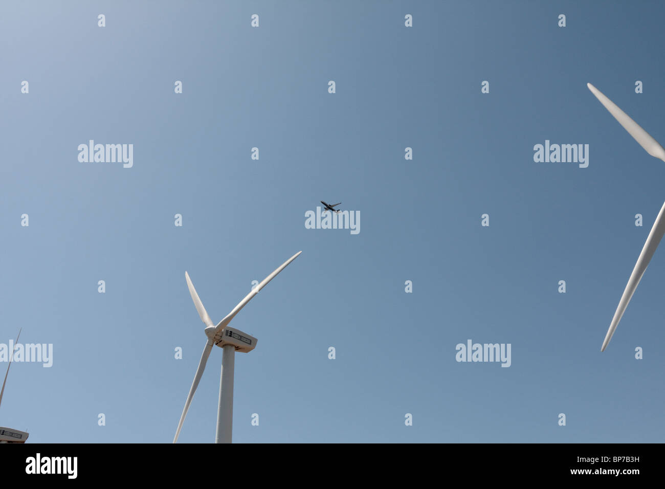 A Ryanair jet takes off from Tenerife airport and flies over the wind turbines at the Parque Eolico in Granadilla Stock Photo