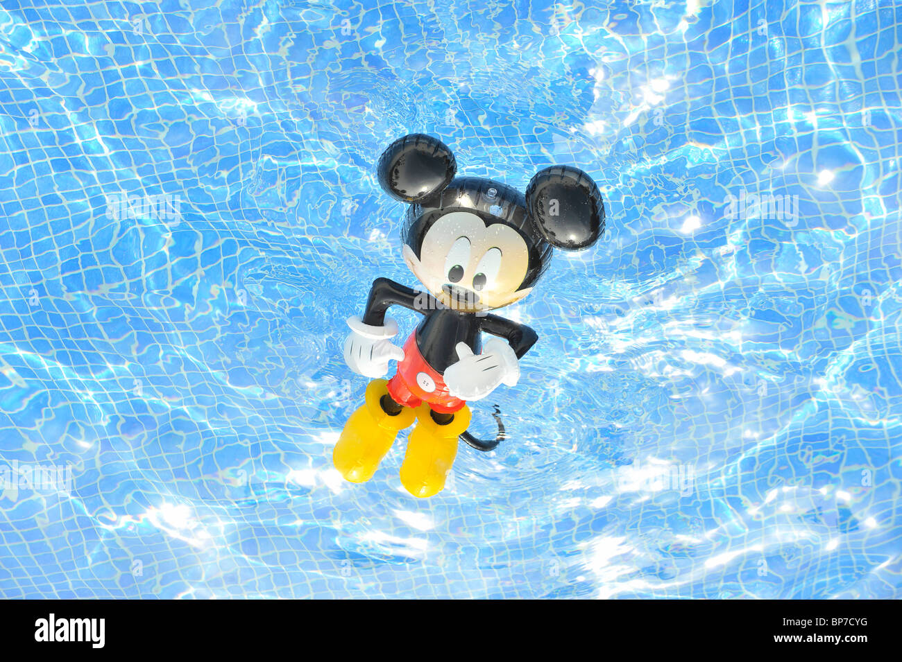 mickey mouse inflatable toy in swimming pool Stock Photo - Alamy