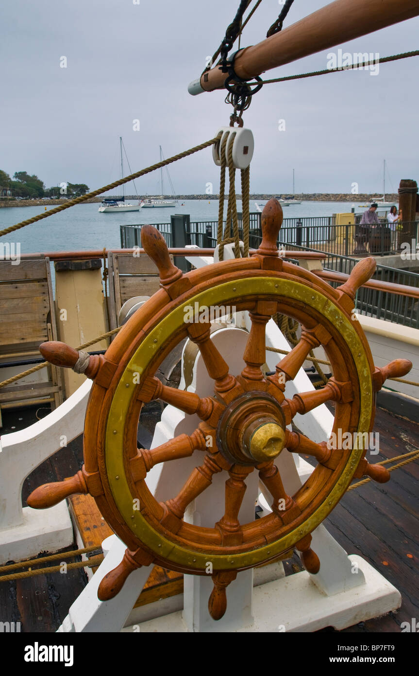 Wooden steering wheel helm aboard The Pilgrim, tall ship docked at Dana