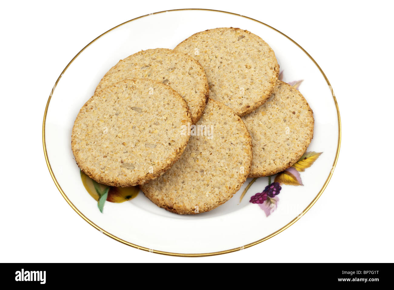 Stack of sunflower and pumpkin seed oatcakes on a white plate Stock Photo