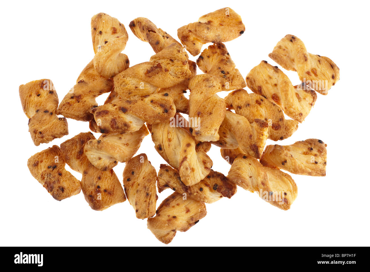 Pile of cheese and onion flaky pastry twists bites gruyere flavour