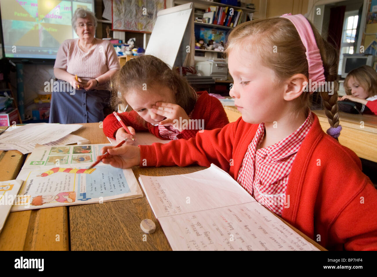 Teacher and primary school children in a english rural school. Stock Photo